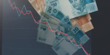 Gráfico financeiro em queda com notas de real, representando a desaceleração da inflação e o IPCA em maio.